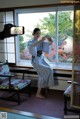 A woman in a kimono taking a picture of herself.