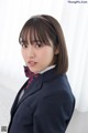 A woman in a school uniform posing for a picture.