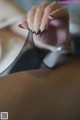 A woman's hand holding a black and gold manicure.