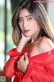 A woman in a red dress posing for a picture.