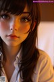 A close up of a woman's face with long brown hair.