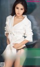 a woman in a white shirt and black panties posing for a magazine